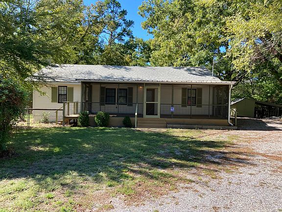 Front of house with large screened in porch.