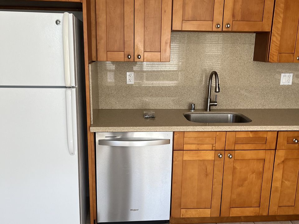 Kitchen - Refrigerator, dishwasher, and sink.