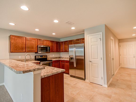 Open kitchen with pantry, soft-close cabinets, and