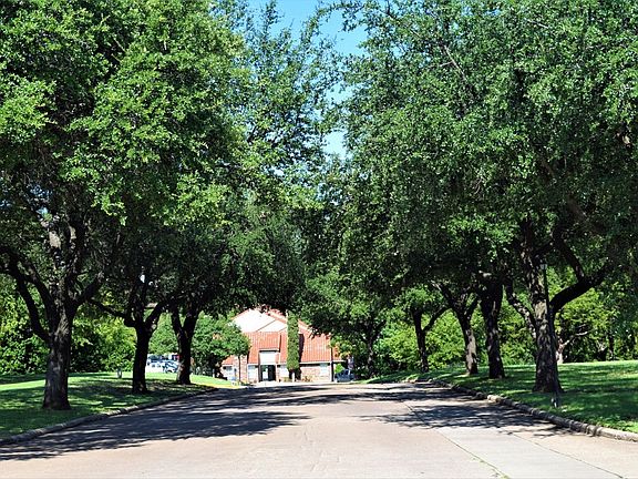Sevilla Apartments walkway with trees