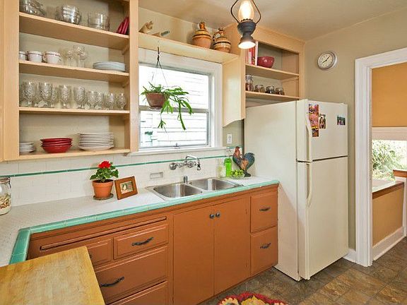 Kitchen with backyard and basement access to the right side of photo.