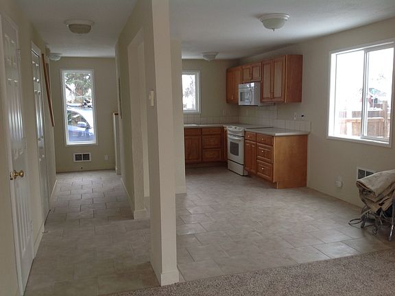 View from living room through dining room to kitchen. Half bath off left hall