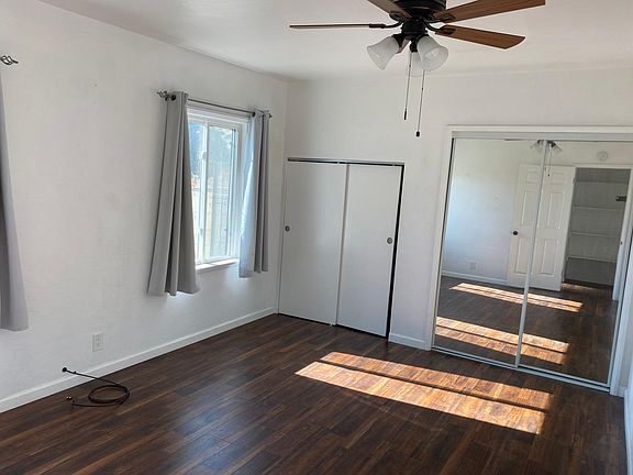 Bedroom has a ceiling fan and cable hookup