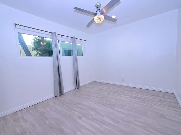 spacious 2nd bedroom with ceiling fans