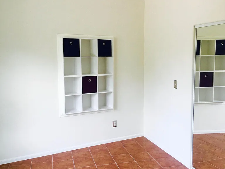 Bedroom wall cubicle storage and closet.