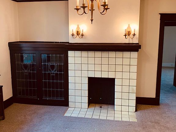 Dining room with decorative fireplace and build in cabinets.