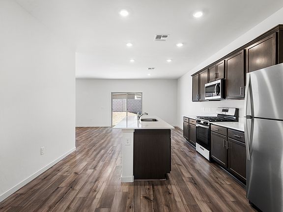 Enjoy stunning granite countertops and designer wood cabinetry in the kitchen.