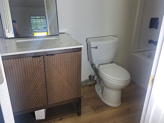 New bathroom with with large soaker tub/shower surround, granite counter, complete renovation