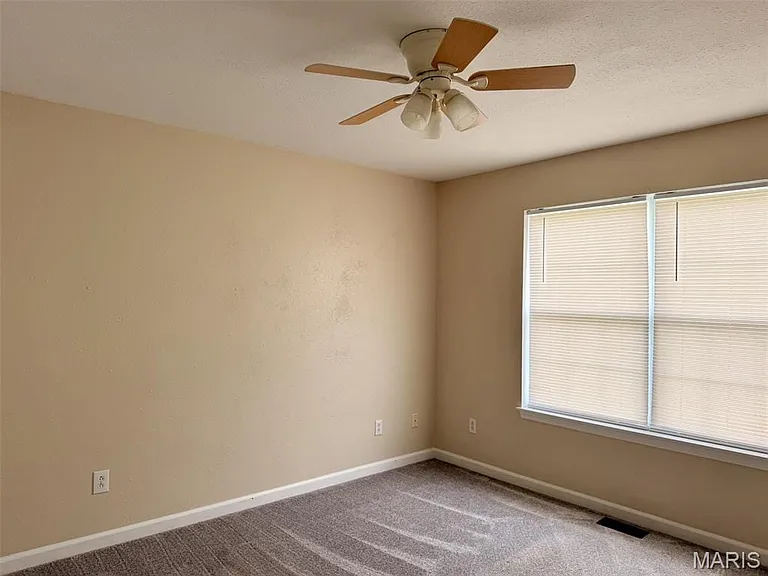 Window with horizontal blinds, overhead ceiling fan with light fixture, and carpeted flooring