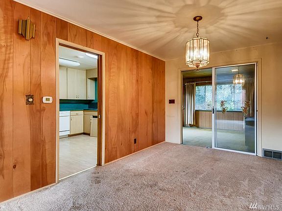 Front room flows into this dining area, with a added sun room