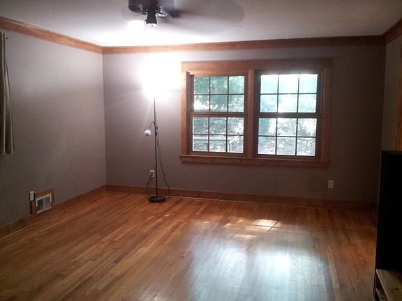 Large, open family room with hardwood flooring