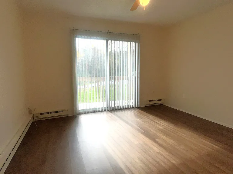 Living room with sliding door to private balcony.