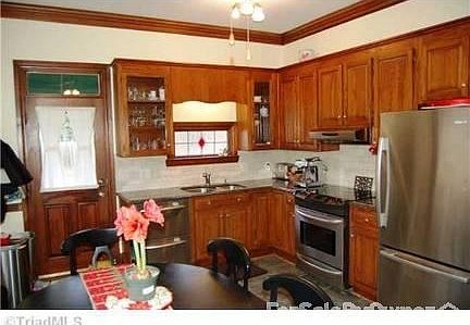 Kitchen : Stained glass, large windows, and plenty of cabinet space, & pantry closet.