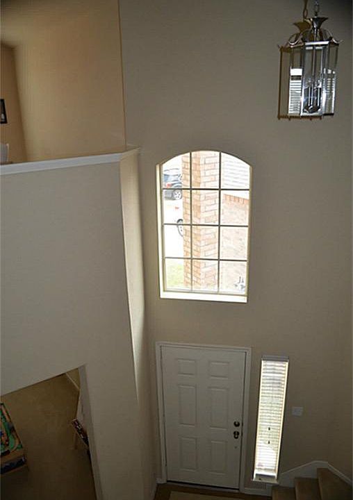 The gorgeous home offers a two story entry with a large window above the door.