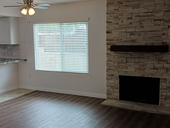 From the foyer walk to the right through separate doorway into the casual family room, with fireplace featuring floor-to-ceiling, stone facade, adjacent to the lighted dining area and convenient breakfast bar with contemporary granite countertop.