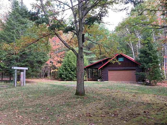 2-car Lincoln log garage with carport and side door entry