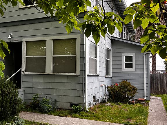 Unit 1 sun room windows facing street and side yard
