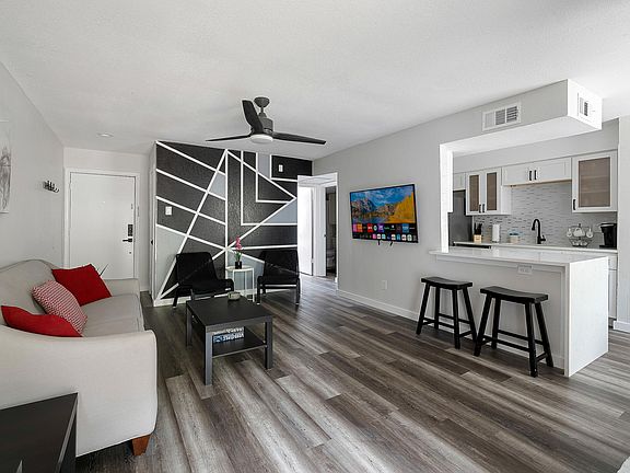 Stylish, modern design. Ceiling fan and big screen Smart TV.