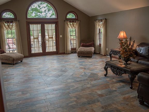 Large living room with French doors to deck at pool.