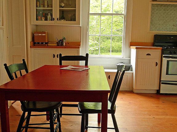 Breakfast/office area in kitchen, glass-front display cabinets