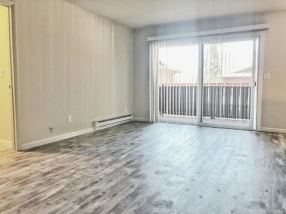 Unit 5 living room with new elegant flooring resembling hardwood