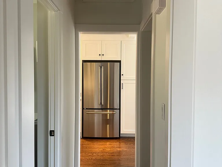Hallway on first floor.
Hallway has access to kitchen, bathroom, bedroom, living room and to basement.