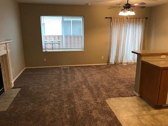 Living and dining area w/new carpet. Slider out to the enclosed patio area.
