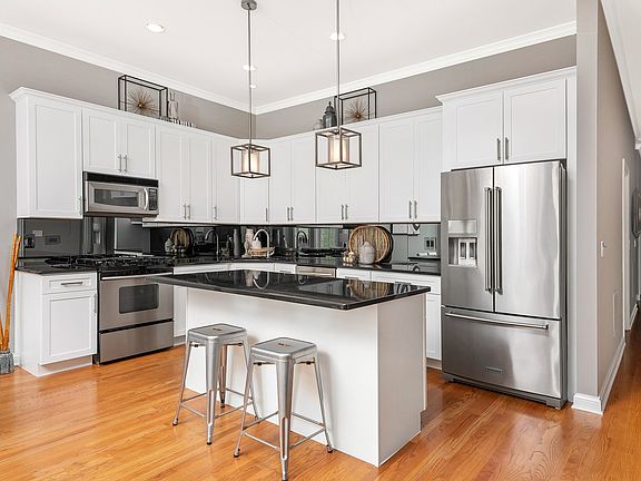 Oversized kitchen cabinets allow for plenty of storage space and the ample counter space makes prepp