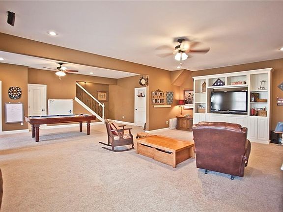 Walk out basement with tons of space. Door to the right of the stairs goes into a fantastic workshop which also has a garage door allowing storage of mower, 4 wheeler, boat. Far left door goes into hobby/craft room.
