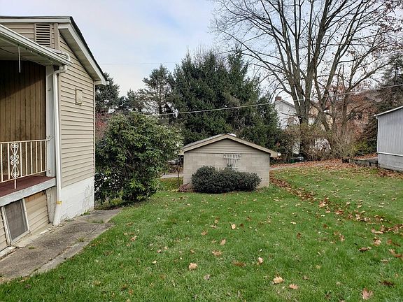 Small porch with yard and back view of garage