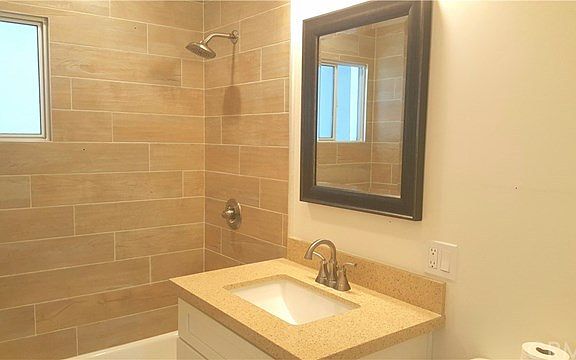 Bathroom quartz  counter-top is matching the one in the kitchen
