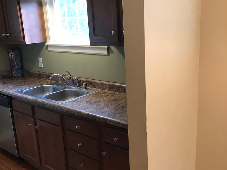 Sunny kitchen window. Dishwasher, microwave with vent fan, fridge/freezer, stove with oven and easy clean top. Cabinet space!