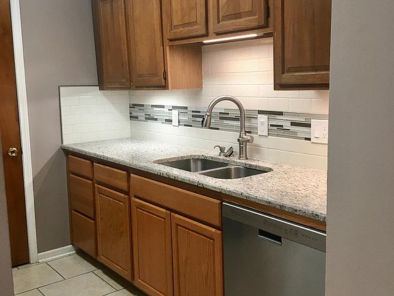 updated kitchen with granite counters and ceramic backsplash; under cabinet lighting; new dishwasher