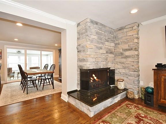 Behind the fireplace wall is the dining area with sliding doors to the sun room.