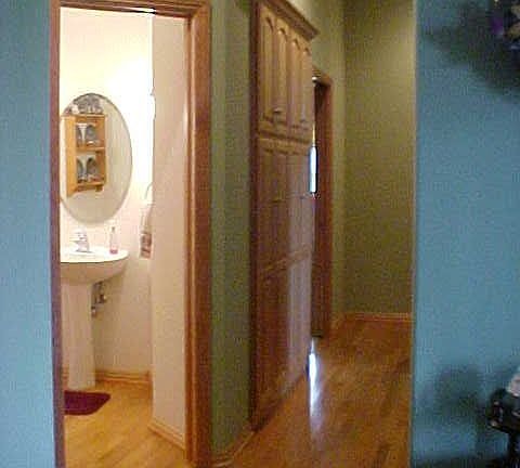 Hallway from entry looking at half bath and hall to bedroom 2