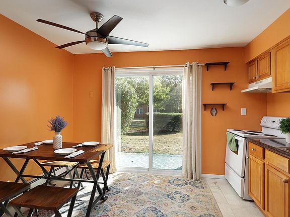 Sundrenched eat-in-kitchen has sliding doors that lead to your own private patio that overlooks a charming courtyard.