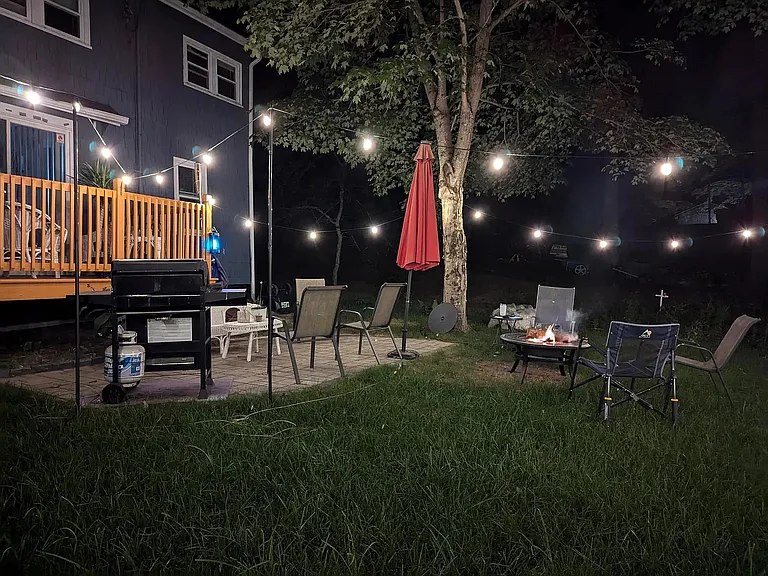 Outdoor patio furniture with gas grill and fire pit.