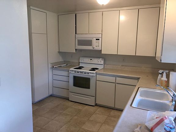 big kitchen lots of cabinets, stove and microwave