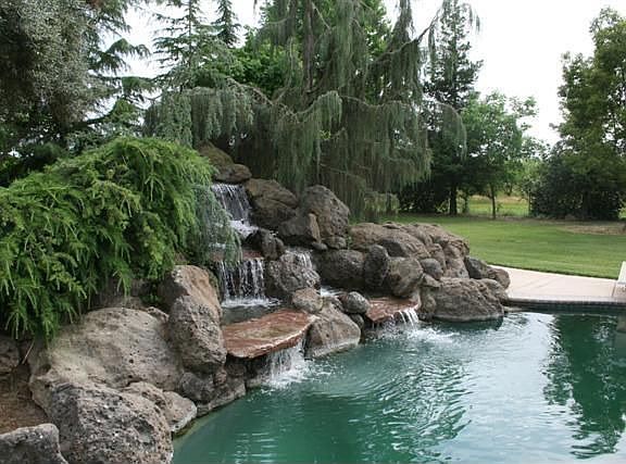 Stunning Fountain Running Into Pool