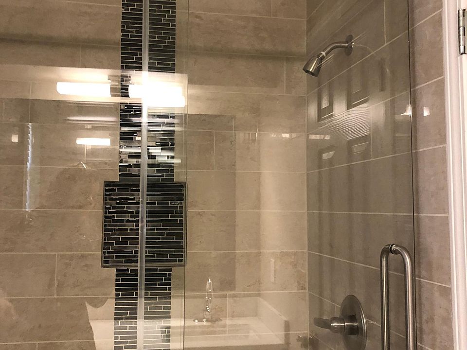 Shower tiled from floor to ceiling.