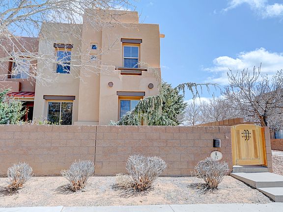 Front of townhouse with apricot trees to the right