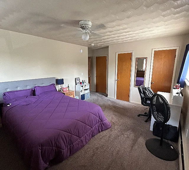Large bedroom looking towards room entrance showing closets