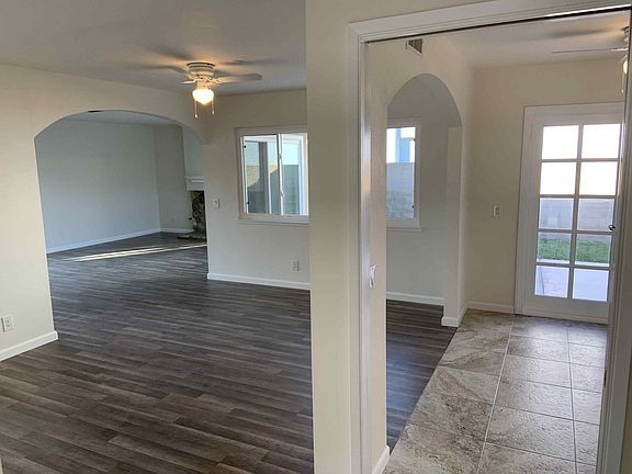Side Arch View of Dining Room Area leading into the Kitchen Area.