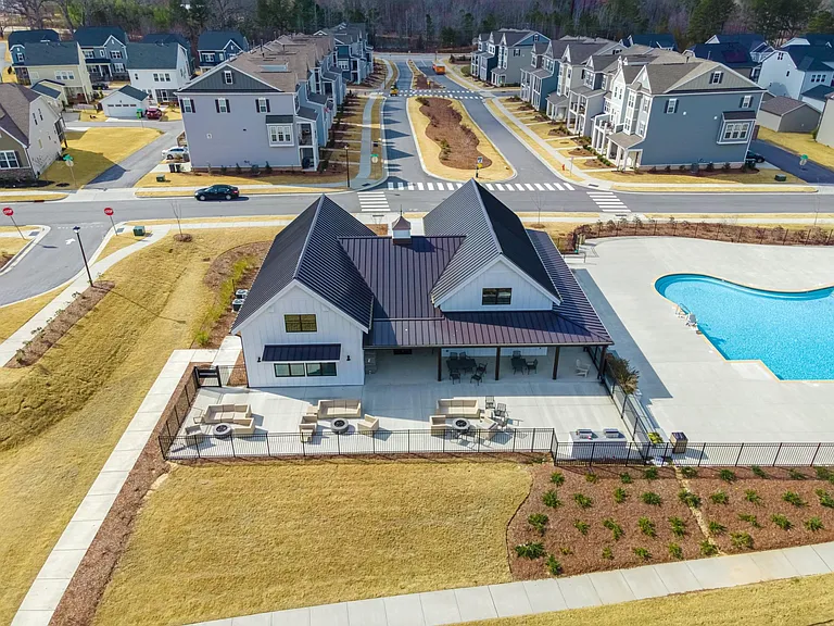 Clubhouse with additional outside seating by firepits, and barbecue/grilling area