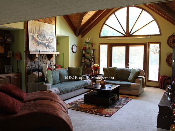 Spacious Living Room with Vaulted Ceiling and Stone Fireplac