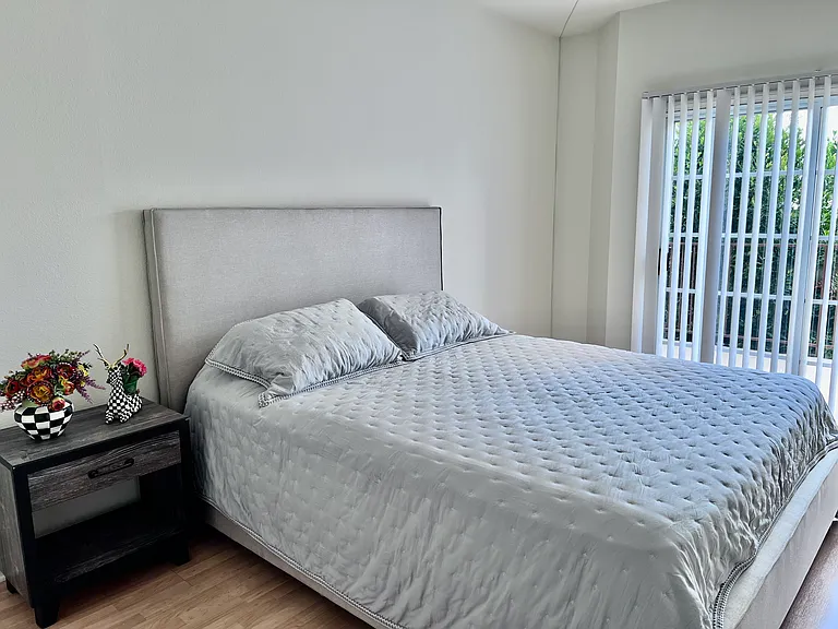 Maste bedroom with walk in closet, ensuite bathroom and sliding door with access to patio.