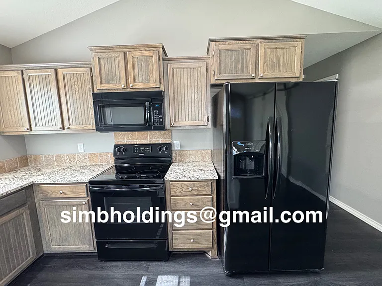 Microwave, electric range and side-by-side fridge included.