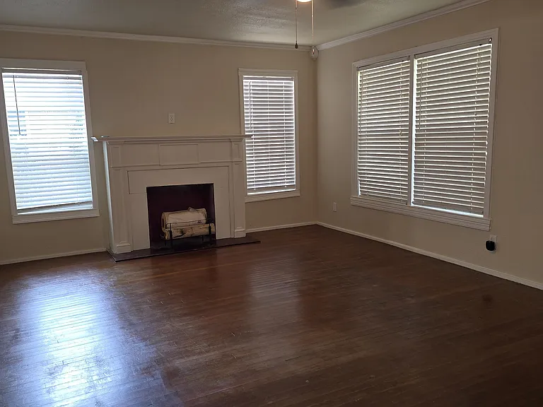 Large formal living room with fireplace and natural light