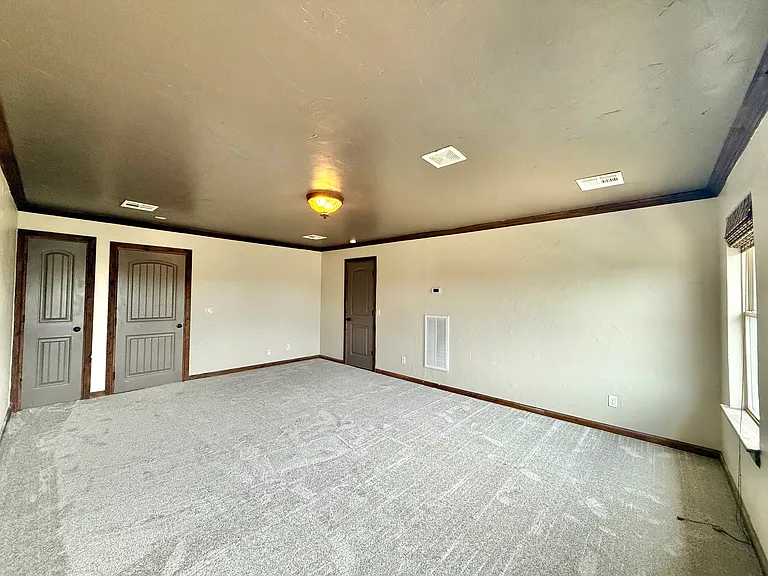 To the far left is the closet. Middle door goes to the staircase for privacy. To the right is access to the attic for storage. Bonus access to the attic from the garage too.

This room is large enough to make a studio apartment.