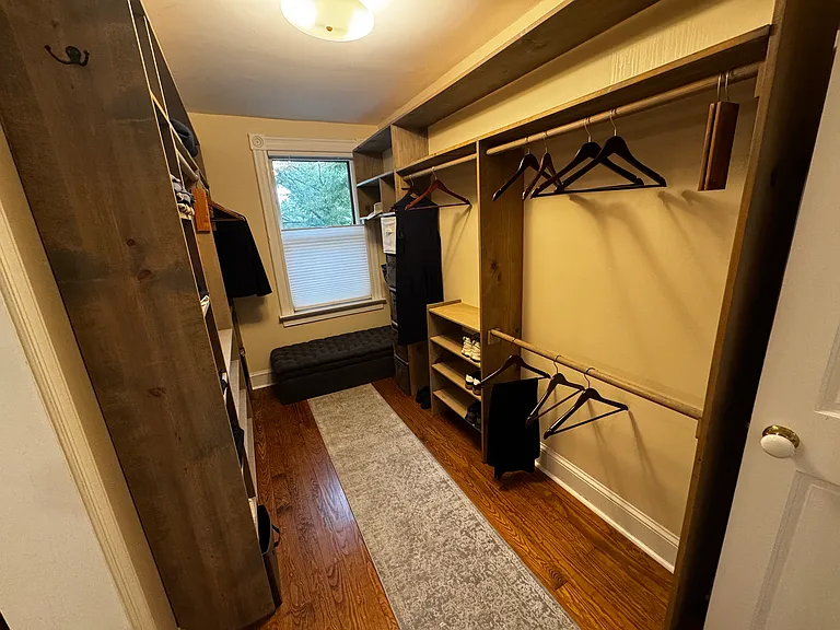 Large walk-in closet of primary bedroom en-suite with access to both ensuite bath and hallway.